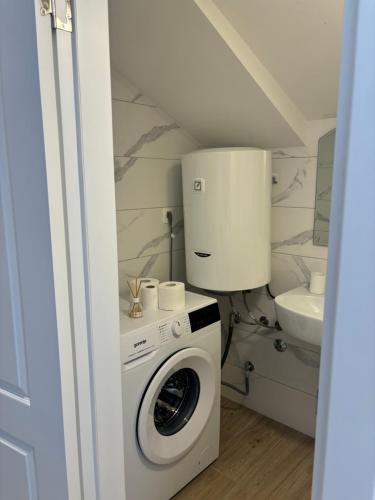 a washing machine in a bathroom with a sink at Apartmani Milos - Meljine in Herceg-Novi