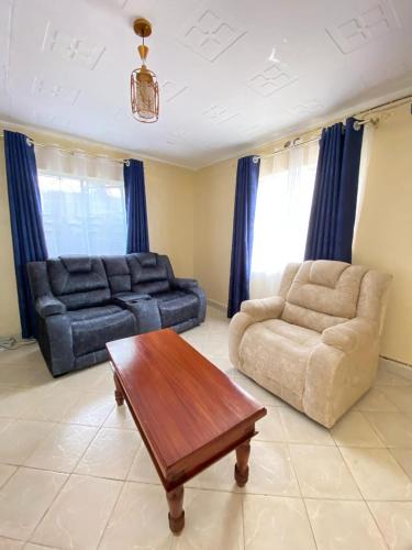 a living room with a couch and a coffee table at 3 Bedroom Fine Executive Homes, Rodi KOPANY HOMABAY in Homa Bay