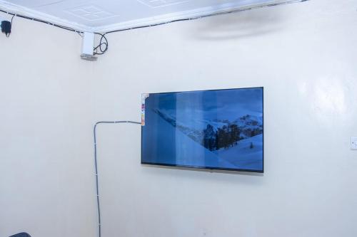 a flat screen tv hanging on a white wall at 3 Bedroom Fine Executive Homes, Rodi KOPANY HOMABAY in Homa Bay