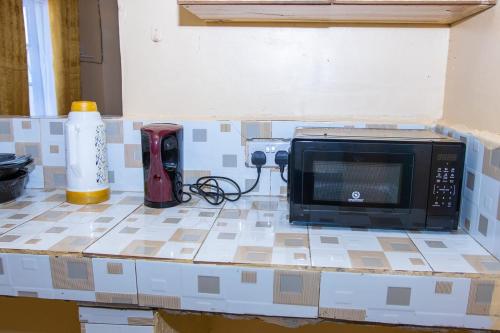 a microwave sitting on top of a kitchen counter at 3 Bedroom Fine Executive Homes, Rodi KOPANY HOMABAY in Homa Bay