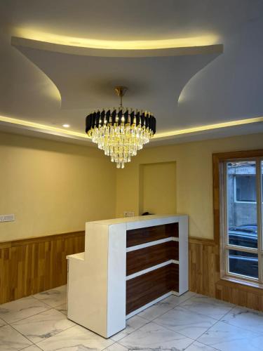 a large room with a chandelier and a counter at The Pineyard Pahalgam in Kolur