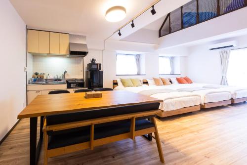 Una gran sala de estar con una cama y una mesa. en The Uchiyama Toko 博多, en Fukuoka