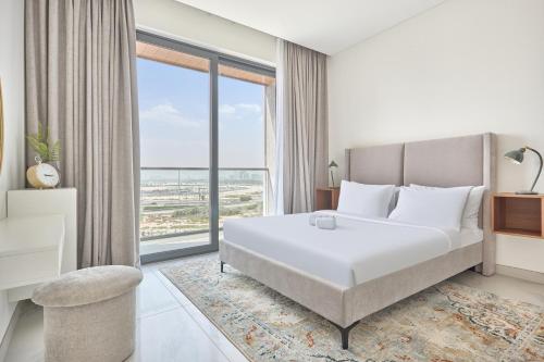 a bedroom with a bed and a large window at STAY BY LATINEM Luxury 2BR Holiday Home OPA 305 Near Downtown in Dubai