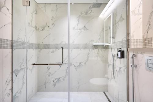 a shower with a glass door in a bathroom at STAY BY LATINEM Luxury 2BR Holiday Home OPA 305 Near Downtown in Dubai