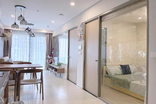 a kitchen and a living room with a dining room at The Sóng Luxury Apartment Vung Tau - Tuấn Hoà Homestay in Vung Tau