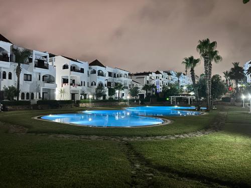 a large swimming pool in front of a building at Cabo garden in Cabo Negro