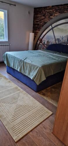 a bed in a room with a brick wall at Apartment Plava Voda in Travnik