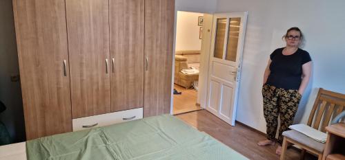 a woman standing in a room next to a door at Apartment Plava Voda in Travnik