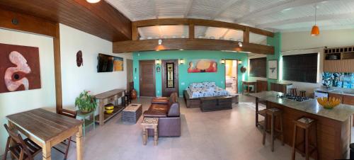 a living room with a couch and a table at Pousada Bem Te Vi in Guarapari