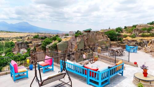 a balcony with chairs and a table and a view at Kapadokya Ihlara Konakları Otel Konak Odaları in Guzelyurt