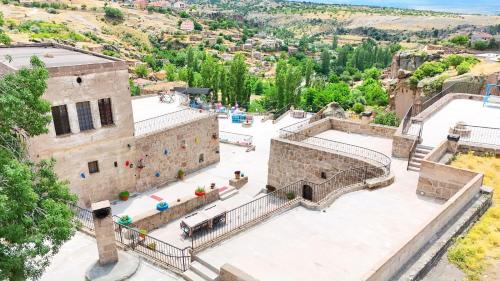 an aerial view of a stone building with stairs at Kapadokya Ihlara Konakları Otel Konak Odaları in Guzelyurt