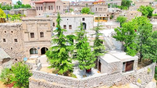 an overhead view of an old building with trees at Kapadokya Ihlara Konakları Otel Konak Odaları in Guzelyurt