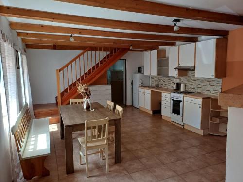 a kitchen and dining room with a table and chairs at Domek v Arnoštově u Pecky 