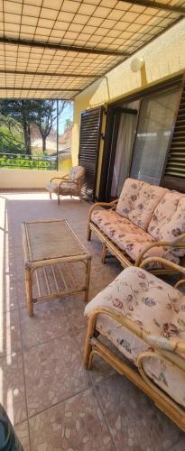 a room with three beds and a table at Guest House SAM-WATER in Ðenovići