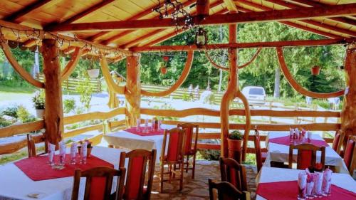 a dining room with tables and chairs in a pavilion at Casa Panaghia in Durău