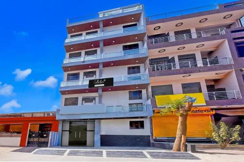 a tall building with a tree in front of it at Hotel Sanwariya in Jaipur