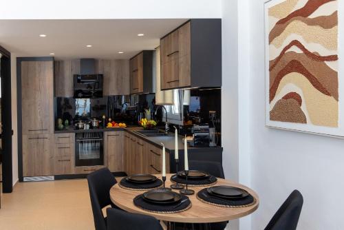 a kitchen and dining room with a table and chairs at Tinian Sunset Suite in Istérnia