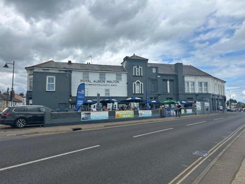 a building on the side of a road next to a street at Royal Albion Walton in Walton-on-the-Naze