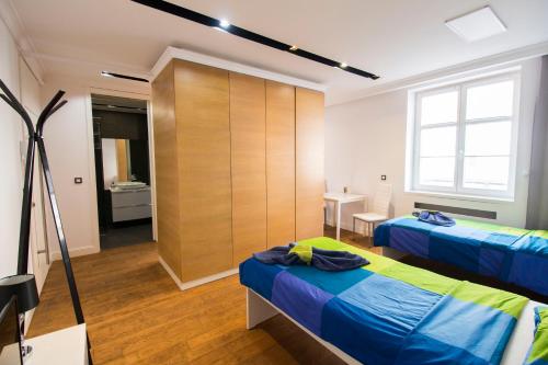 a bedroom with two beds and a closet at HappyEstate Apartments 3 min do Rynku in Wrocław