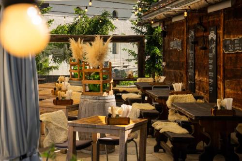 a restaurant with tables and chairs and plants at Sonnmatten Boutique Hotel & Apartments Zermatt in Zermatt
