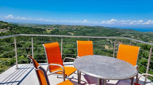 a table and chairs on a balcony with a view at Apartma Olivia in Šmarje