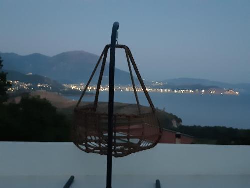 a basket hanging from a pole on a balcony at Villa vista mare in Zagrađe