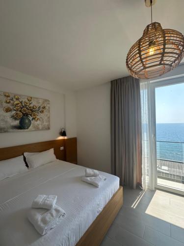 a bedroom with a bed and a large window at Serenity In in Lezhë