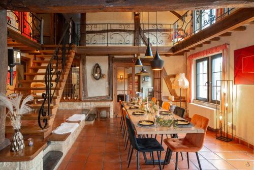 a dining room with a long table and chairs at La Pastorale in Manhay