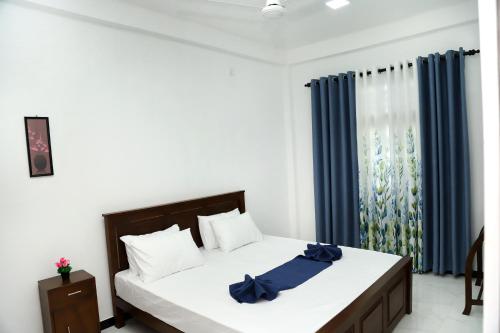 Ένα ή περισσότερα κρεβάτια σε δωμάτιο στο Sandakini Home Rest