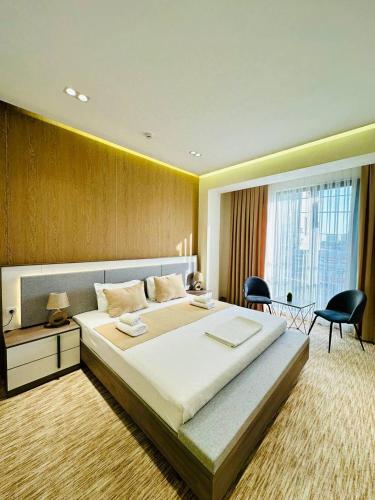 a bedroom with a large bed and a table and chairs at North Star Hotel in Yakkasaray