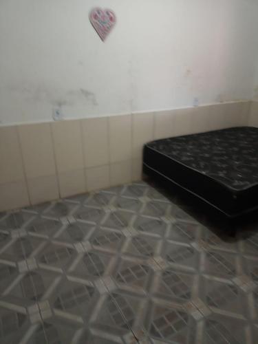 a room with a bed in the corner of a room at Casa da Diversidade para todos in Peruíbe