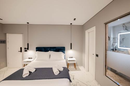 a bedroom with a large bed with towels on it at Hotel Elite Sarande in Sarandë