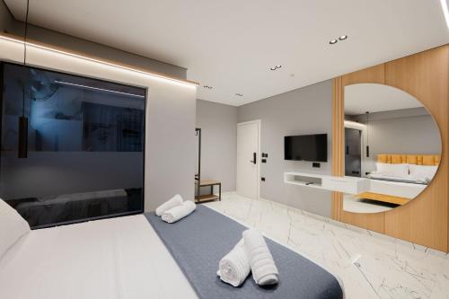 a bedroom with a large bed with two towels at Hotel Elite Sarande in Sarandë