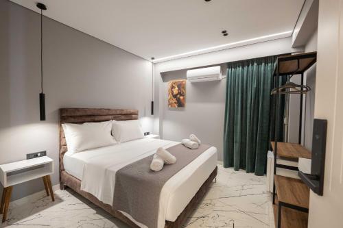 a bedroom with a bed with a teddy bear on it at Hotel Elite Sarande in Sarandë