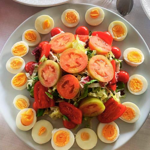 a plate of eggs and salad on a table at T'AMI Hotel Resort Spa in Selvino