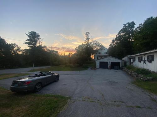 a car parked in the driveway of a house at Charming Farmhouse - Holiday Hills 