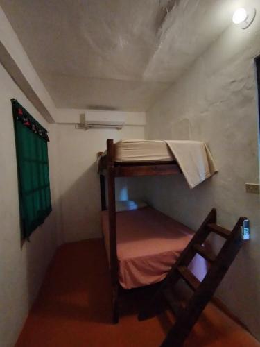 a small room with a bunk bed in it at Hibiscus Garden in Santa Catalina