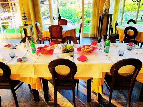 a table with a yellow table cloth and fruit on it at T'AMI Hotel Resort Spa in Selvino