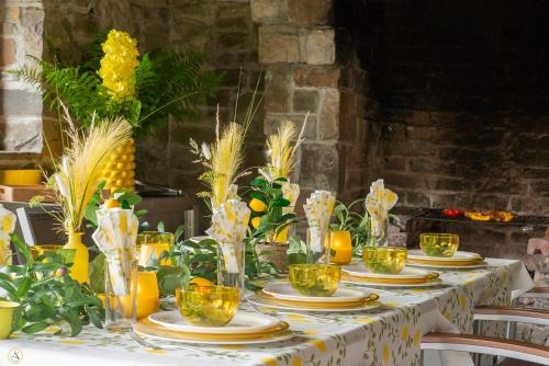 a table with plates and glasses of oranges on it at La Pastorale in Manhay
