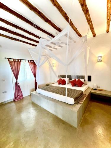 a bedroom with a white bed in a room at Beba.Beach.House in Watamu