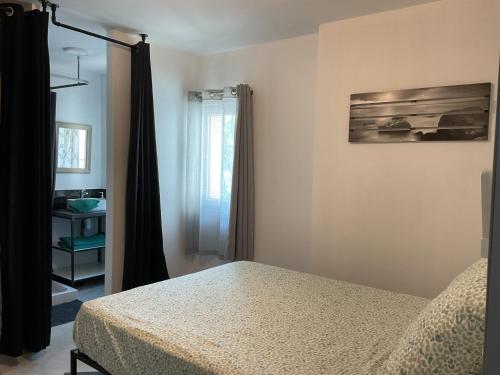 a bedroom with a bed and a window at Domaine Le Rocher d Argent avec Piscine Extérieur ,Jacuzzi Intérieur et Salle de jeux in Berre-les Alpes