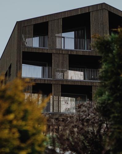 a building with balconies on the side of it at Mountain Residence Montana in Santa Maddalena in Casies