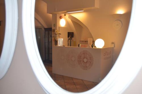 a mirror on a wall in a room at Hotel RivaMia in Riva del Garda