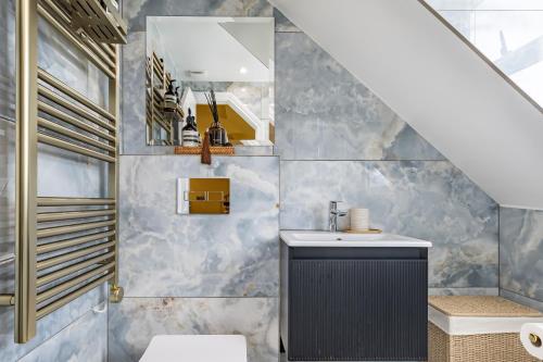 a bathroom with a sink and a mirror at Maison Rokxy - Luxury Apartments in London