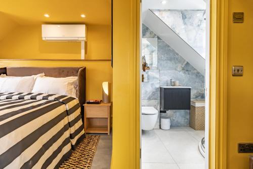 a bedroom with a bed and a bathroom at Maison Rokxy - Luxury Apartments in London