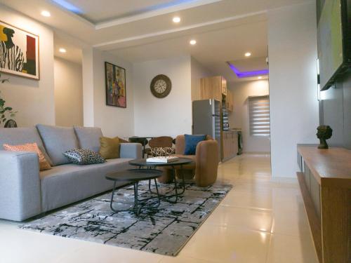 a living room with a couch and a table at Discovery Apartments in Lekki