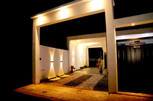 an entrance to a house at night with a door at Sandakini Home Rest in Ahangama