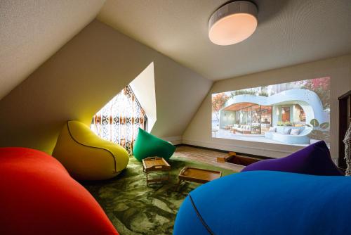 a living room with colorful furniture and a large window at The Uchiyama Toko 博多 in Fukuoka