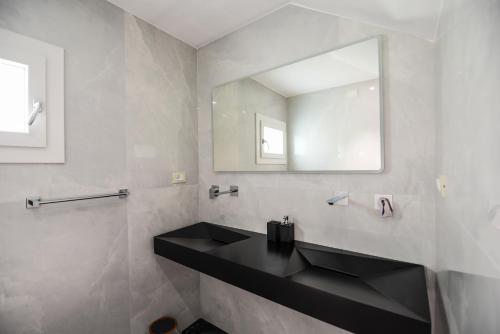 a bathroom with a black sink and a mirror at HOTEL Mirarti in Rapallo