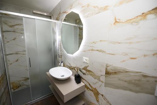 a bathroom with a white sink and a mirror at HOTEL Mirarti in Rapallo